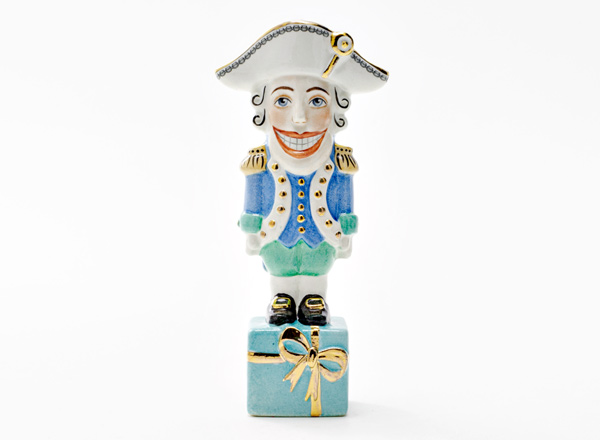 Christmas tree toy Nutcracker on a turquoise gift
