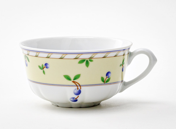 Cup tea Small berries on a pale yellow background Rose