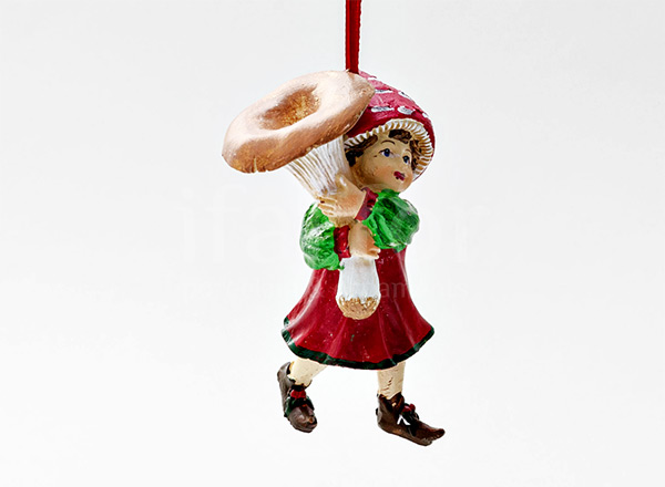 Christmas tree toy Picking of mushrooms. Girl with a redhead