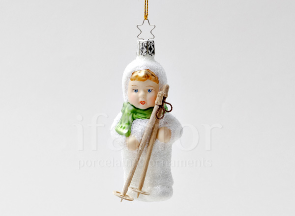 Christmas tree toy Childrens games in the snow. Little skier
